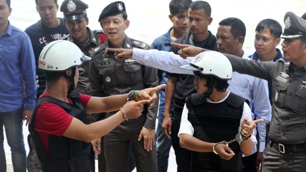 The two Myanmar men were made to take part in a re-enactment of the crime.