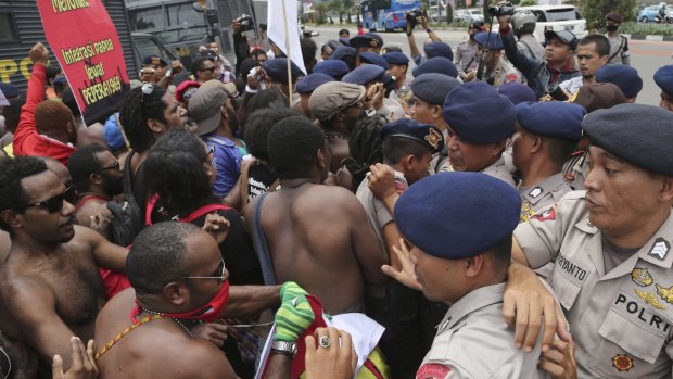 Activists scuffle with police during a rally marking the 53rd anniversary of the Free Papua Movement in Jakarta on December 1.