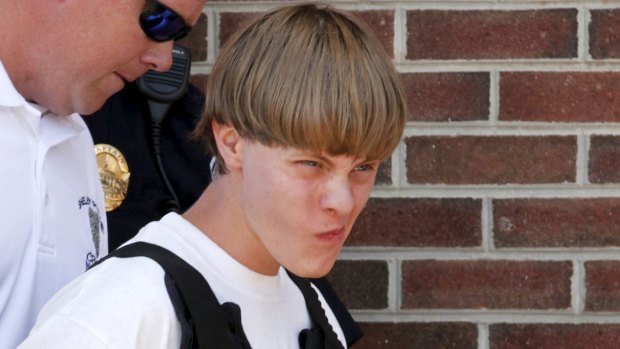 Police lead suspected shooter Dylann Roof, 21, into the courthouse in Shelby, North Carolina.