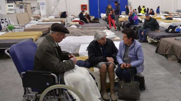Elderly residents spend Sunday night in a shelter set in a warehouse in Caldarola, Italy.