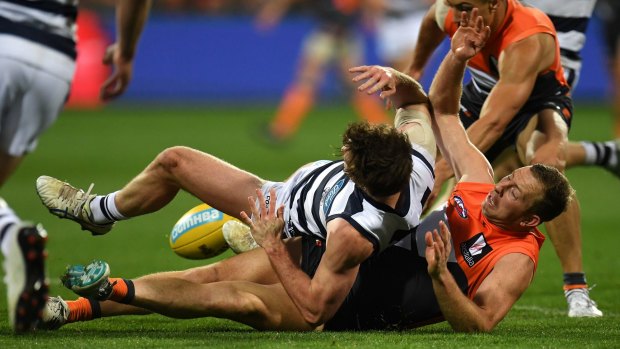 Poor night: Steve Johnson gets tangled up with Jed Bews of the Cats on the ground.