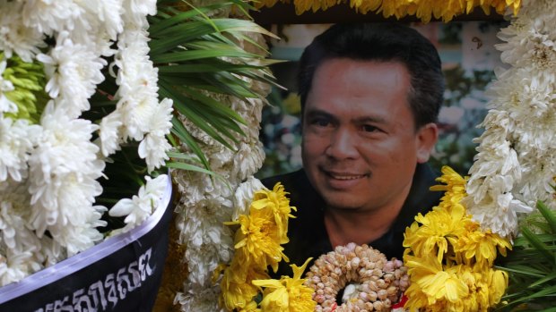 A wreath with a framed picture of murdered Cambodian commentator Kem Ley. 