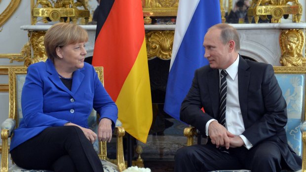 German Chancellor Angela Merkel listens to Russian President Vladimir Putin, right, at the Elysee Palace in Paris on Friday.