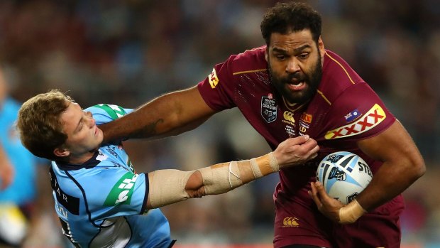 Arm's length: Sam Thaiday fends Matt Moylan off.