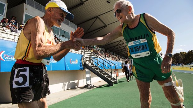 Dumitru Radu, left, a 90-year-old Romanian, and Australian John Gilmour, 97, after both ran in the 800 meter event -- both were the only competitors in their different age groups -- at the World Masters Athletics Championships in Perth.