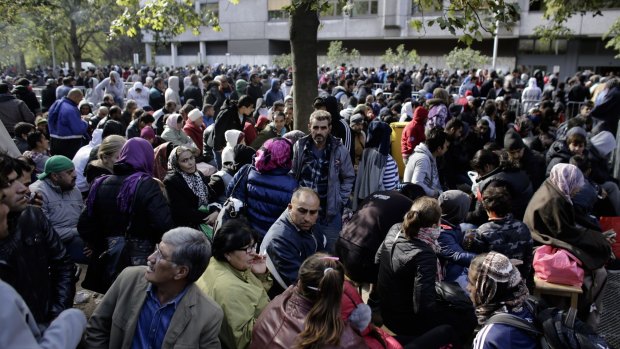 Refugees wait outside a registration office in Berlin.