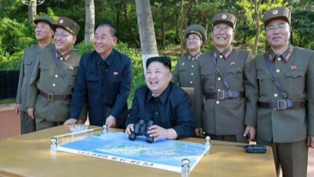 Kim Jong Un, centre, watches the test launch of missile at an undisclosed location in North Korea.