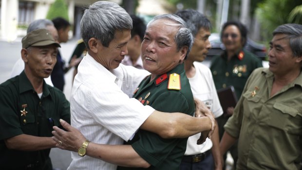 Vietnamese veteran  Nguyen Van Tap (centre right), who drove the tank that crashed through the gate of the Presidential Palace in Saigon in 1975, and a friend who served along with him in the same tank company.