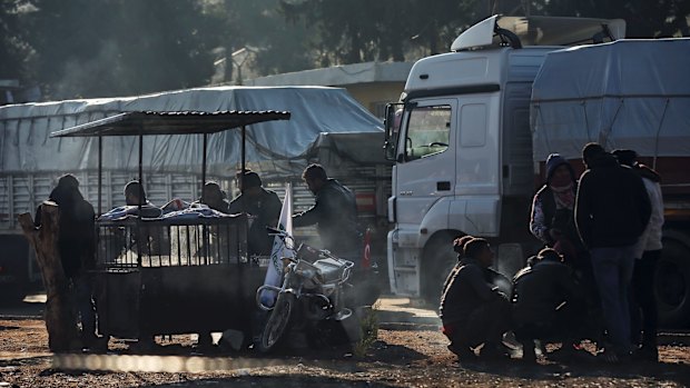 People wait at the Cilvegozu border gate with Syria, near Hatay, south-eastern Turkey.