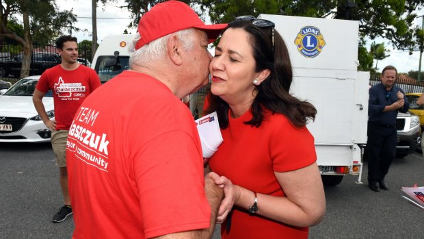 Queensland Premier Annastacia Palaszczuk greets her father, Henry, as she arrives at Inala State School in Brisbane to cast her vote.