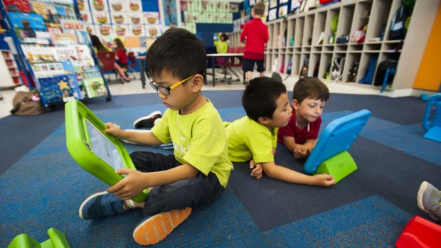 Preschoolers Chilok Yu, Jun You Wang and Jesse Lord, all 4, enjoy the ELLA iPads at Franklin Early Childhood School.