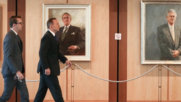 Prime Minister Tony Abbott heads to a meeting in Parliament House on Friday.