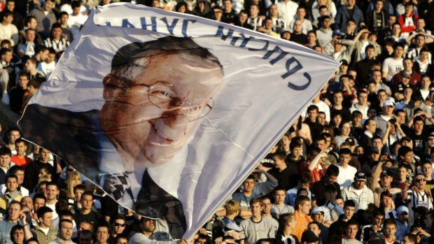 Supporters wave a flag showing Serbian ultranationalist Vojislav Seselj at a soccer match in Belgrade, Serbia, in 2008.