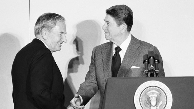 Rockefeller shakes hands with President Ronald Reagan at the State Department in 1981.