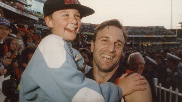 Tim Watson with son Jobe after the 1993 grand final.