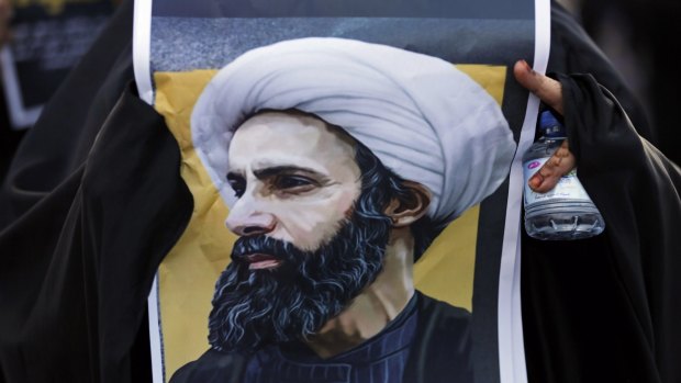 A Bahraini protester holds a picture of Saudi Shiite cleric Sheikh Nimr al-Nimr during a rally denouncing his execution by Saudi Arabia.