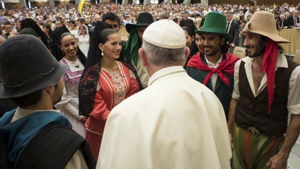 Pope Francis greets the faithful during a general audience at the Vatican.