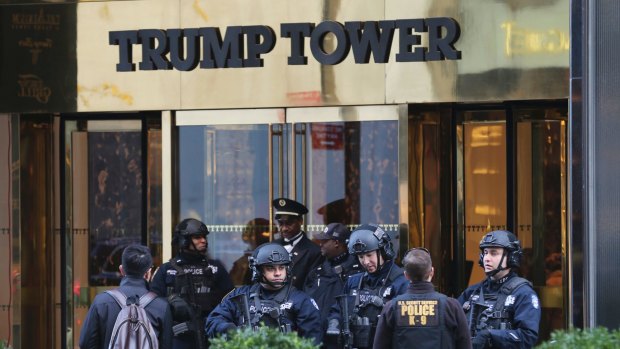 New York City Police Department officers stand at the front entrance of Trump Tower in New York. The new federal spending bill would allocate $61 million to reimburse primarily New York City and Palm Beach County for police overtime.