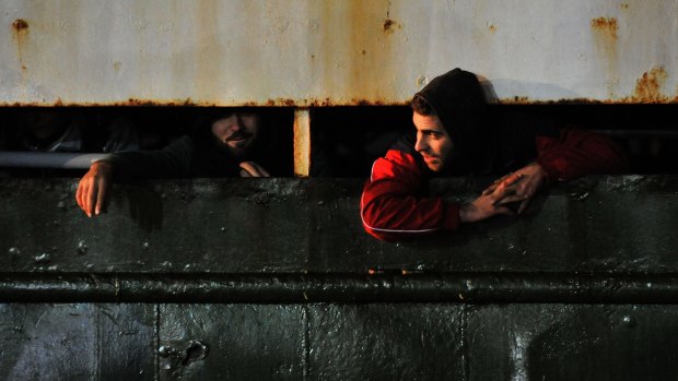 Syrian migrants arrive in the Italian port of Corigliano aboard a rusty ship.