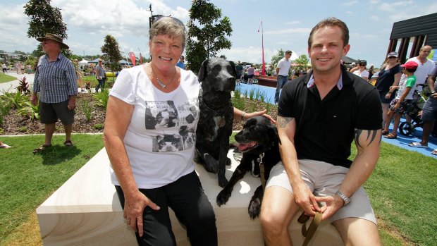 Charlene Simpson poses with real life and statue Sarbi, the Australian Special Forces explosives detection dog, and her son, handler Warrant Officer David Simpson.