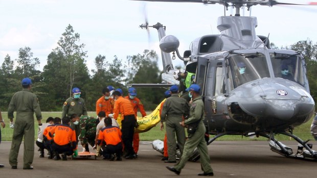 Indonesian rescue personnel unload body bags from a military helicopter in Pangkalan Bun on Thursday.