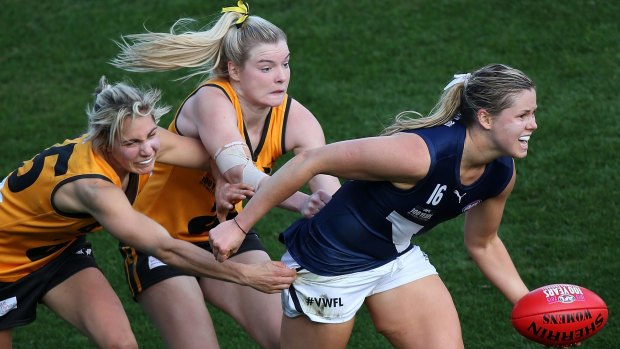 Hayley Miller, centre, played out Saturday's inaugural women's western derby match with a broken leg. 