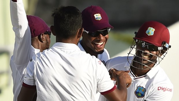 West Indies duo Devendra Bishoo (second from left) and captain Denesh Ramdin (far right) combined to remove Australia captain Michael Clarke late on the opening day of the first Test, at Windsor Park in Dominica.