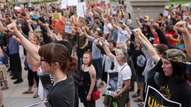 Supporters of Philando Castile hold their fists up in solidarity during a gathering on Friday after Jeronimo Yanez was cleared in his death.