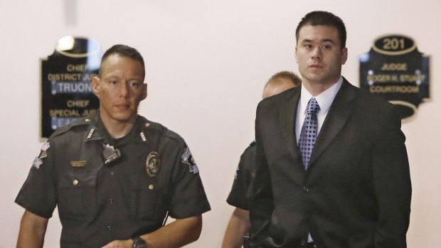 Daniel Holtzclaw, right, is escorted to a courtroom in Oklahoma City, on Monday for jury selection in his trial.
