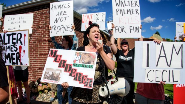 Rachel Augusta leads a group of protesters in front of Walter Palmer's dental practice.