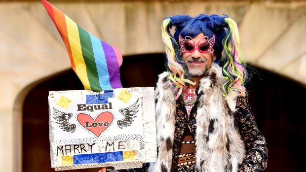 'Love is an awful thing to hate': A supporter of marriage equality at the Sydney rally.
