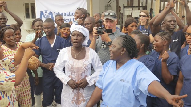 Adama Sankoh, 35, centre, who contracted Ebola after her son died from the disease, is discharged on Monday.