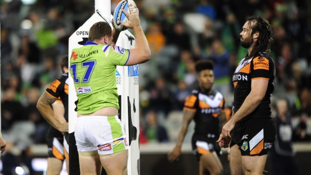 Shannon Boyd of Canberra Raiders goes over for a try as James Tedesco looks on.