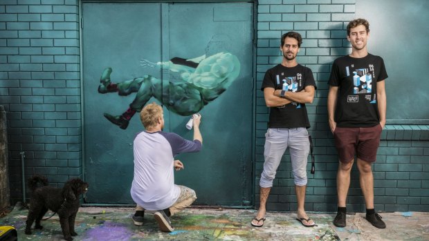 Lincoln Savage and David Don, directors of the Brisbane Street Art Festival, with artist Joel Fergie.