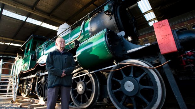 The Australian Railway Historical Society ACT's Bruce Blain with steam locomotive 1210, which brought the first train to Canberra 100 years ago, is part of the collection. 