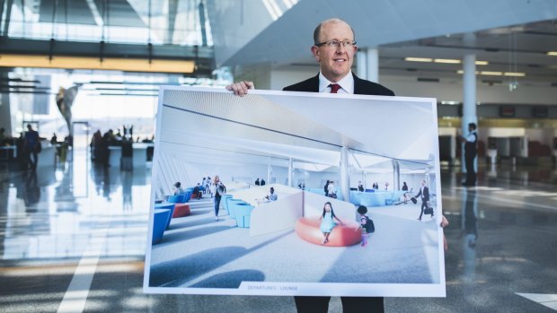 Canberra Airport general manager Stephen Byron with plans for the new international lounge.
