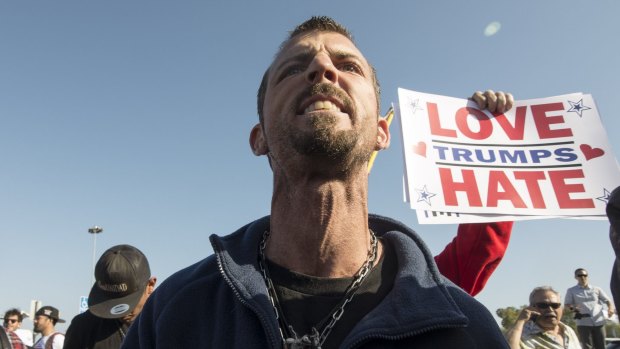 Andreas Dixon, an anti-Trump demonstrator, confronts a Trump supporter in Costa Mesa.