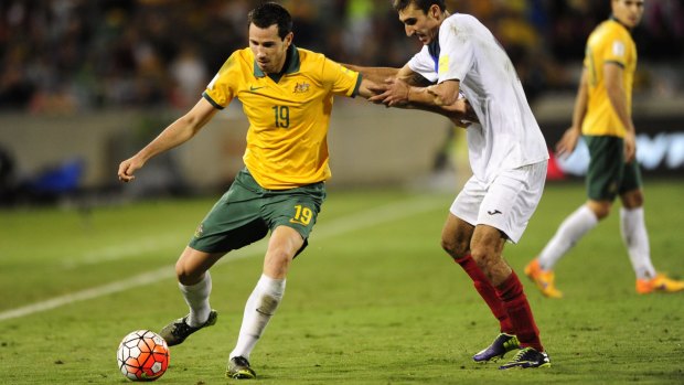 Socceroos defender Ryan McGowan and Kyrgyzstan player Amirov Ildar challenge for the ball in Thursday night's World Cup qualifier at Canberra Stadium.
