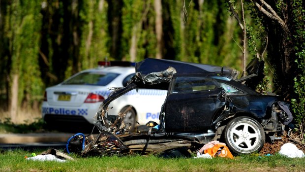 Car split in two ... Four people died in the Canberra Avenue crash.