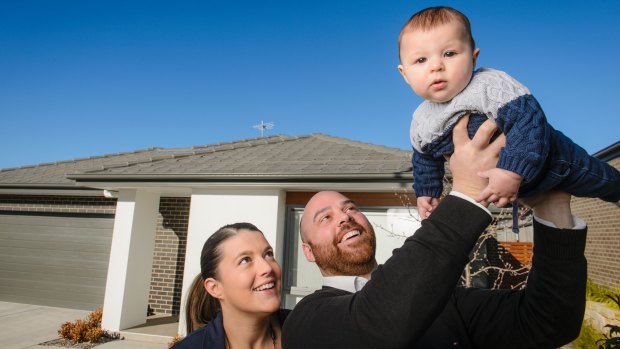 Sophie Victory, Nick Paine and five-month-old Oscar at home in Casey. They bought their four-bedroom house just over two years ago for $580,000.