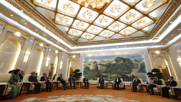 China's President Xi Jinping (4th from the right) and guests at the Asian Infrastructure Investment Bank (AIIB) launch ceremony at the Great Hall of the People in Beijing last October.