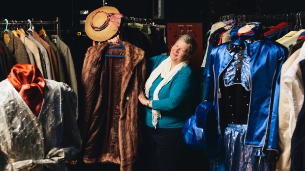 Canberra Repertory Society's Liz de Totth with some of the vintage clothes on sale as part of the society's 85th birthday celebrations.
