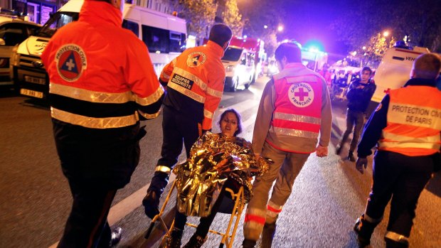 A person is evacuated after a shooting, outside the Bataclan Theatre in Paris.