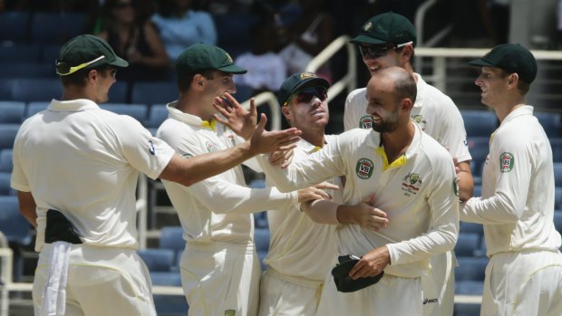 Australia's Nathan Lyon (no cap) is congratulated by his teammates after taking two wickets in consecutive deliveries to end the West Indies' second innings a seal a 277-run win, and with it a 2:0 series clean sweep, on day four of the second Test at Sabina Park, Jamaica.