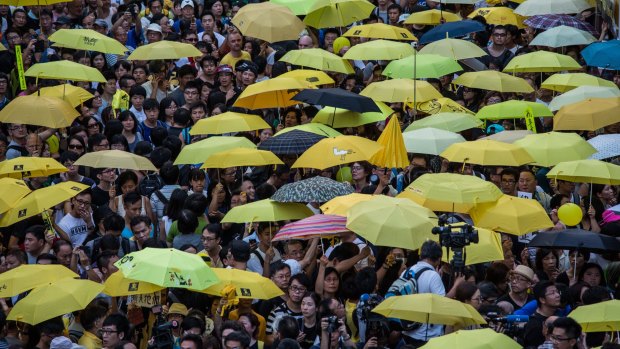 Pro-democracy activists hold yellow umbrellas as they gather in Hong Kong.