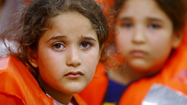 Children on a Migrant Offshore Aid Station ship wait to be transferred to a Norwegian ship off the coast of Libya in August.