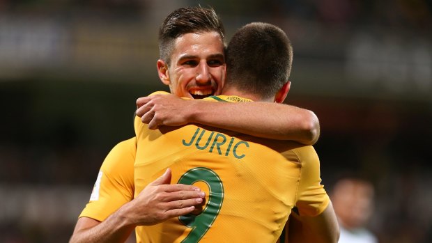 Milos Degenek congratulates Tom Juric after Juric scored a goal against Iraq.