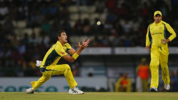 Australia's Mitchell Starc takes a catch to dismiss Sri Lanka's Suranga Lakmal.