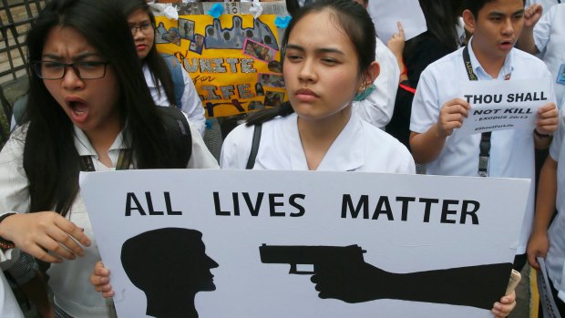 Filipino students display placards in protest of the killings being perpetrated in the unrelenting "War on Drugs" campaign of President Rodrigo Duterte.