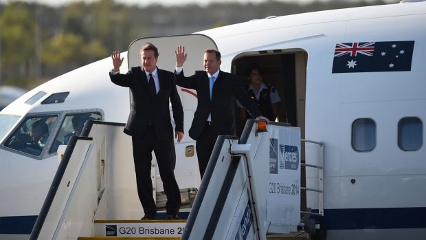 David Cameron and Tony Abbott leave their aircraft at Brisbane Airport. 